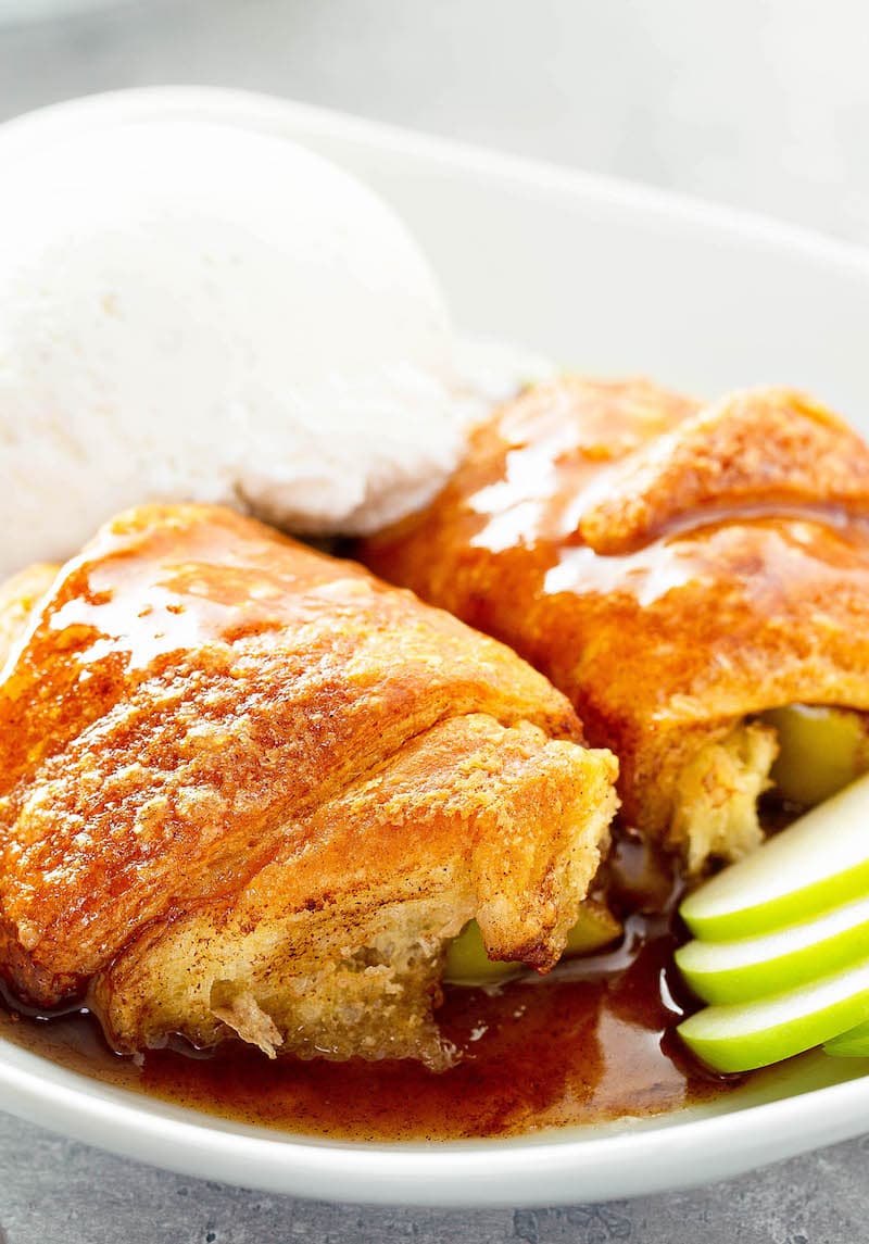 Apple Dumplings in a bowl with vanilla ice cream.