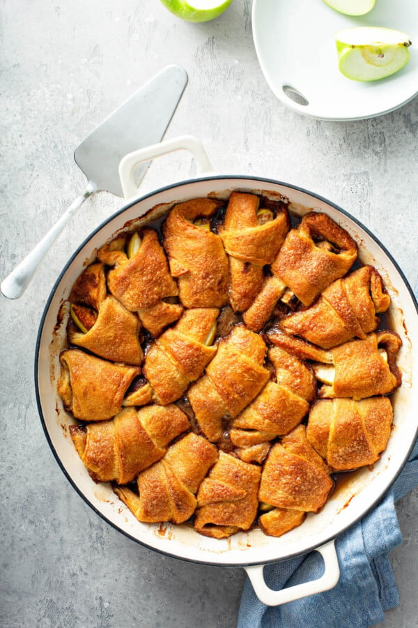 Overhead image of apple dumplings in a casserole dish after baking. 