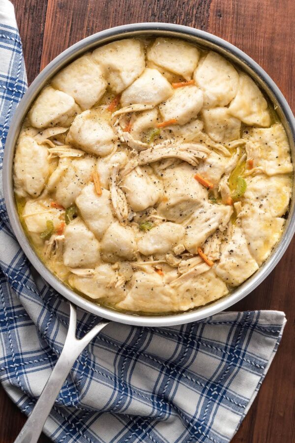 Overhead photo of Easy Chicken and Dumplings in a skillet with a blue napkin