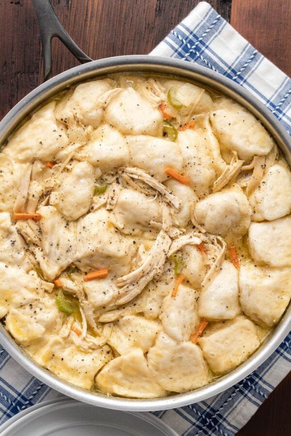 Up close image of chicken and biscuit dumplings in a skillet. 