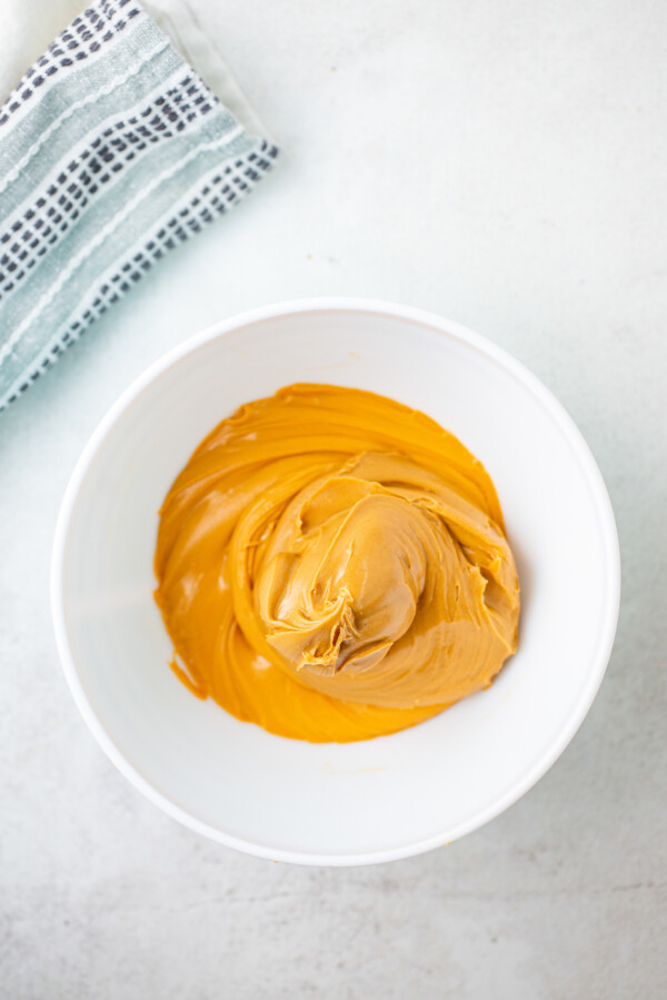 A bowl of peanut butter and butterscotch, bended together.