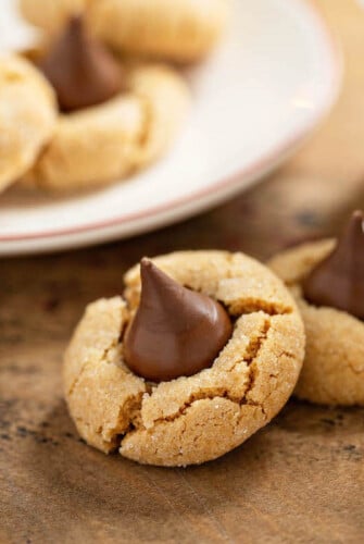 These Peanut Butter Blossoms are a Christmas tradiiton! Sweet peanut butter cookies are rolled in sparkling sugar, with a milk chocolate kiss in the center! #PeanutButterBlossoms #PeanutButterBlossomsRecipe #PeanutButterBlossomCookie #Dessert #ChristmasCookie #Cookie #CookieRecipe #ChristmasCookieRecipe #PeanutButterCookie #PeanutButterCookieRecipe #PeanutButterKissCookies #ChristmasRecipes #PeanutButter