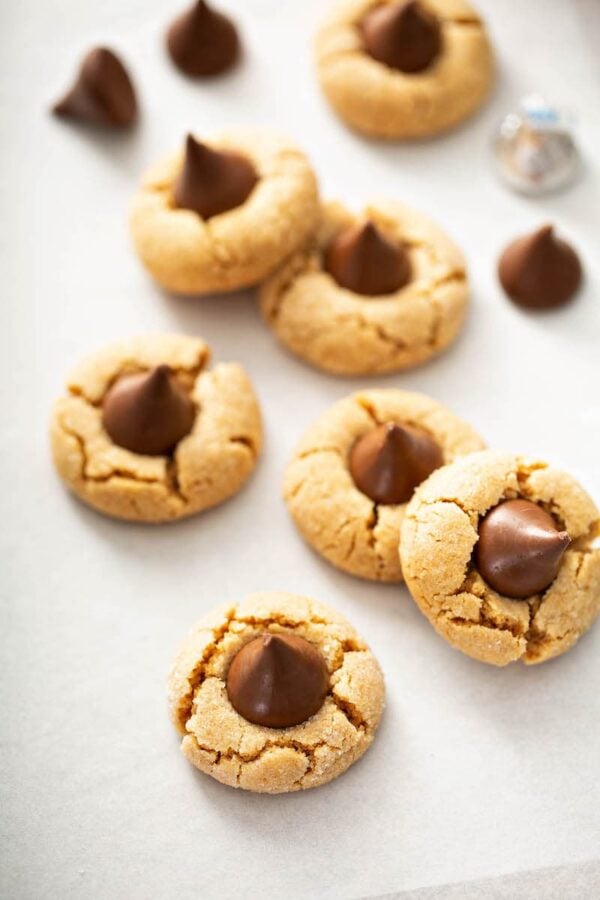 Peanut Butter Kiss Cookeis on parchment paper after baking.