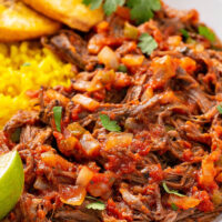 Ropa Vieja is a classic Cuban dish that is bursting with bold flavor! Flank steak is slow cooked all day and shredded in a rich and flavorful sauce with onions, peppers and garlic. #RopaVieja #RopaViejaRecipe #CubanRecipes #Cuban #SlowCookerRopaVieja #CrockpotRopaVieja #BeefRecipes #FlankSteakRecipes #CrockpotRecipes #SlowCookerRecipes