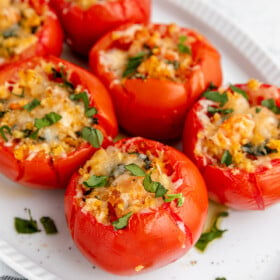 Cheese stuffed tomatoes garnished with herbs.