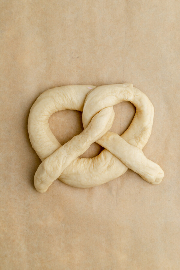 Dough shaped into a traditional pretzel shape.