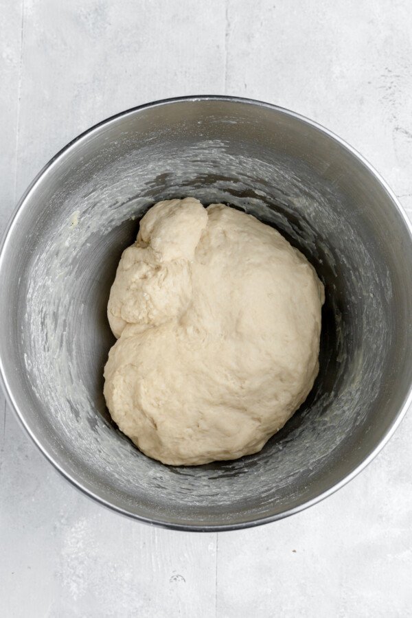 A ball of yeast dough in a greased bowl.