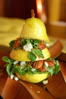 a pear sliced in thirds stuffed with salad