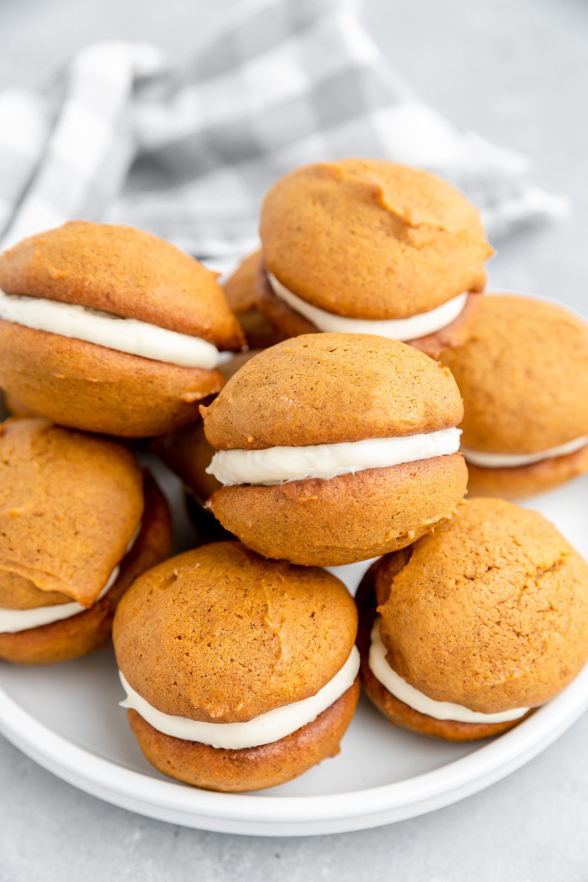 A heap of pumpkin dessert cookies on a plate.