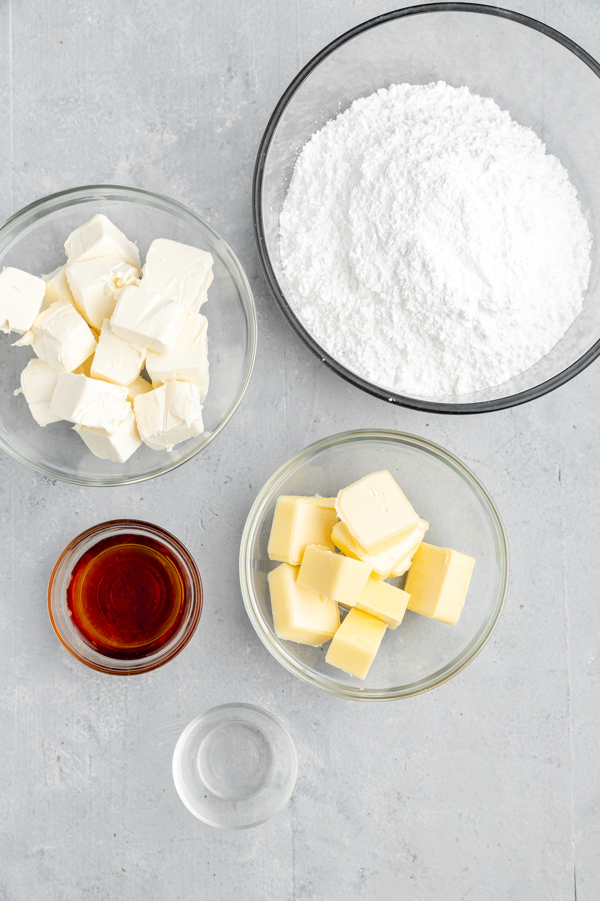 From top left: Cubed cream cheese, powdered sugar, maple syrup, cubed butter, vanilla.