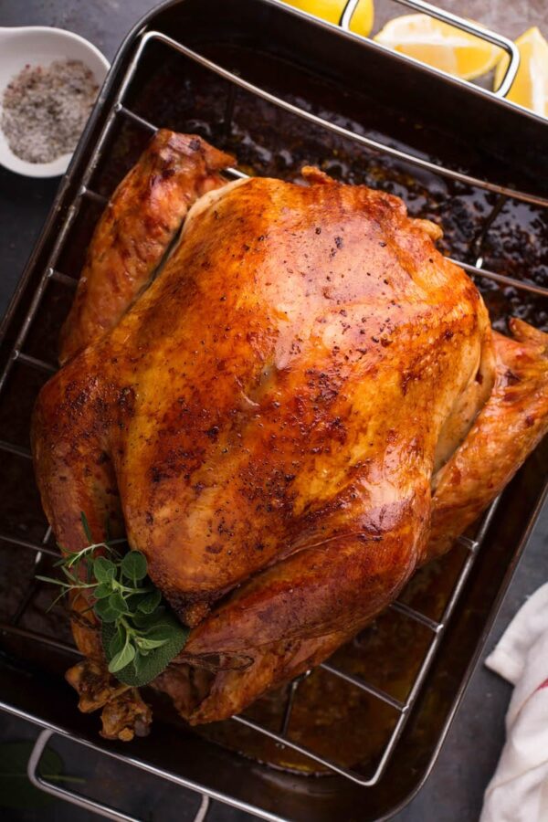 A cooked Thanksgiving turkey in a roasting rack.