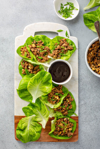 Lettuce wraps platted with dipping sauce.