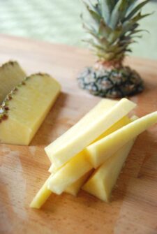 Pineapple with the top cut off cut into slices.