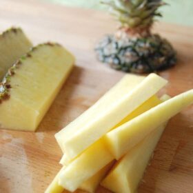 Pineapple with the top cut off cut into slices.