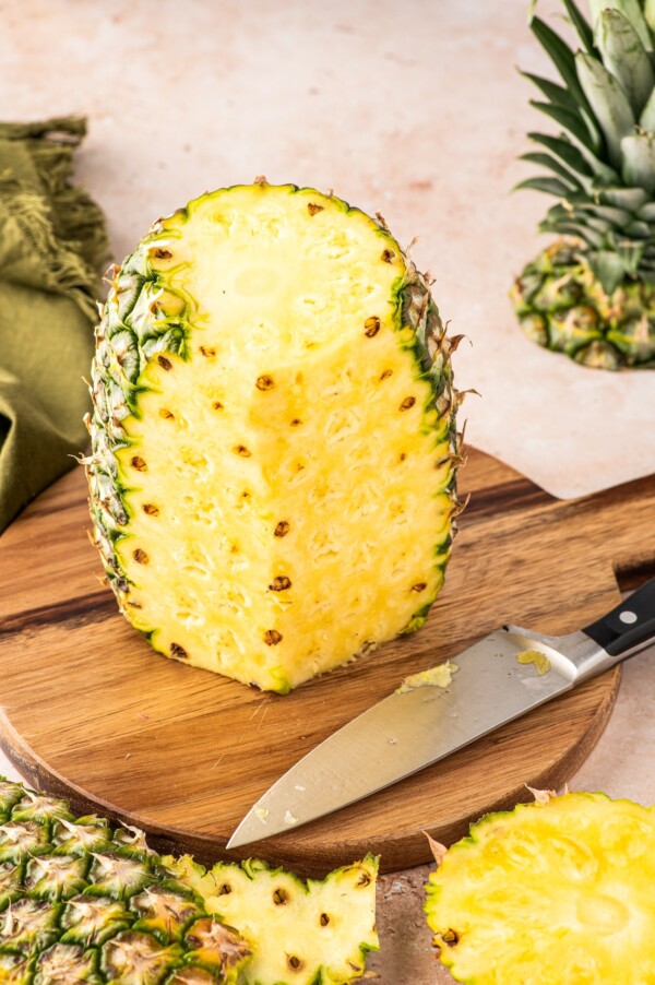 Removing the spiky rind from the fruit.