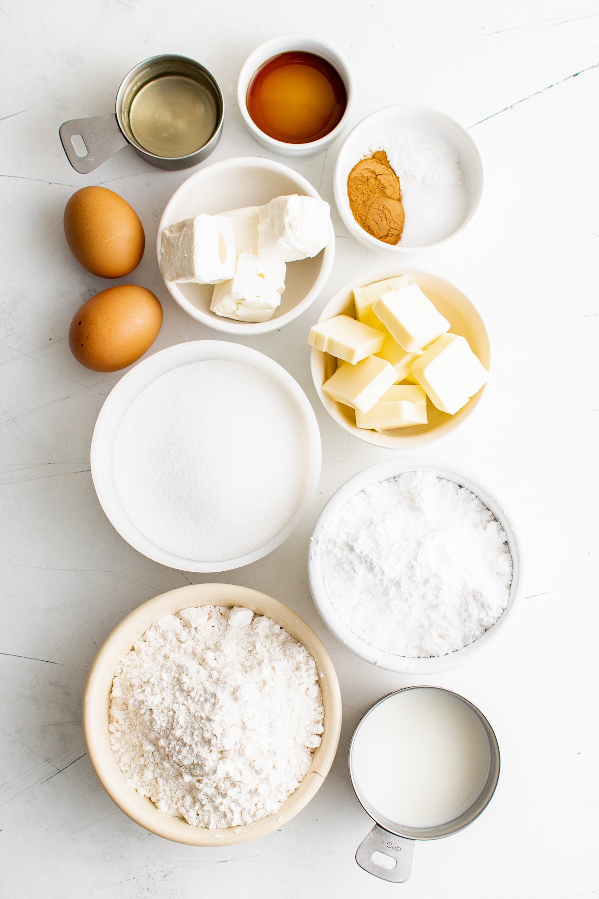 From top: vegetable oil, vanilla, eggs, cream cheese, butter, sugar, flour, confectioner's sugar, milk.