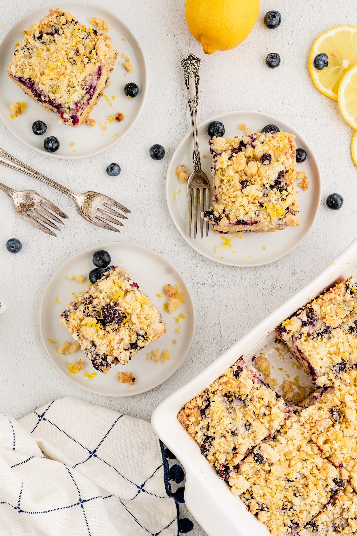 Overhead view of squares of lemon blueberry cake on plates