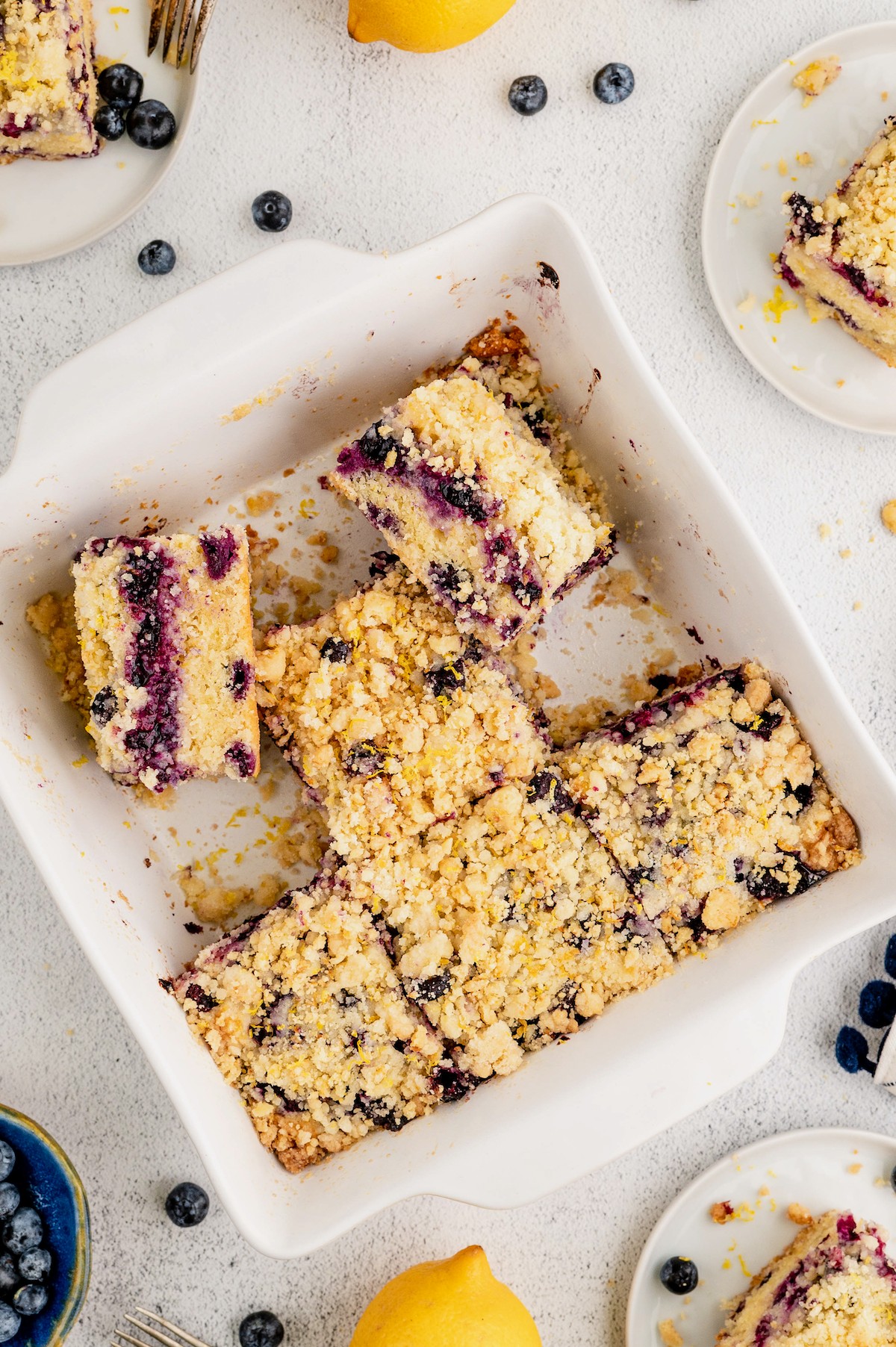 Overhead view of a pan of blueberry buckle with several slices missing