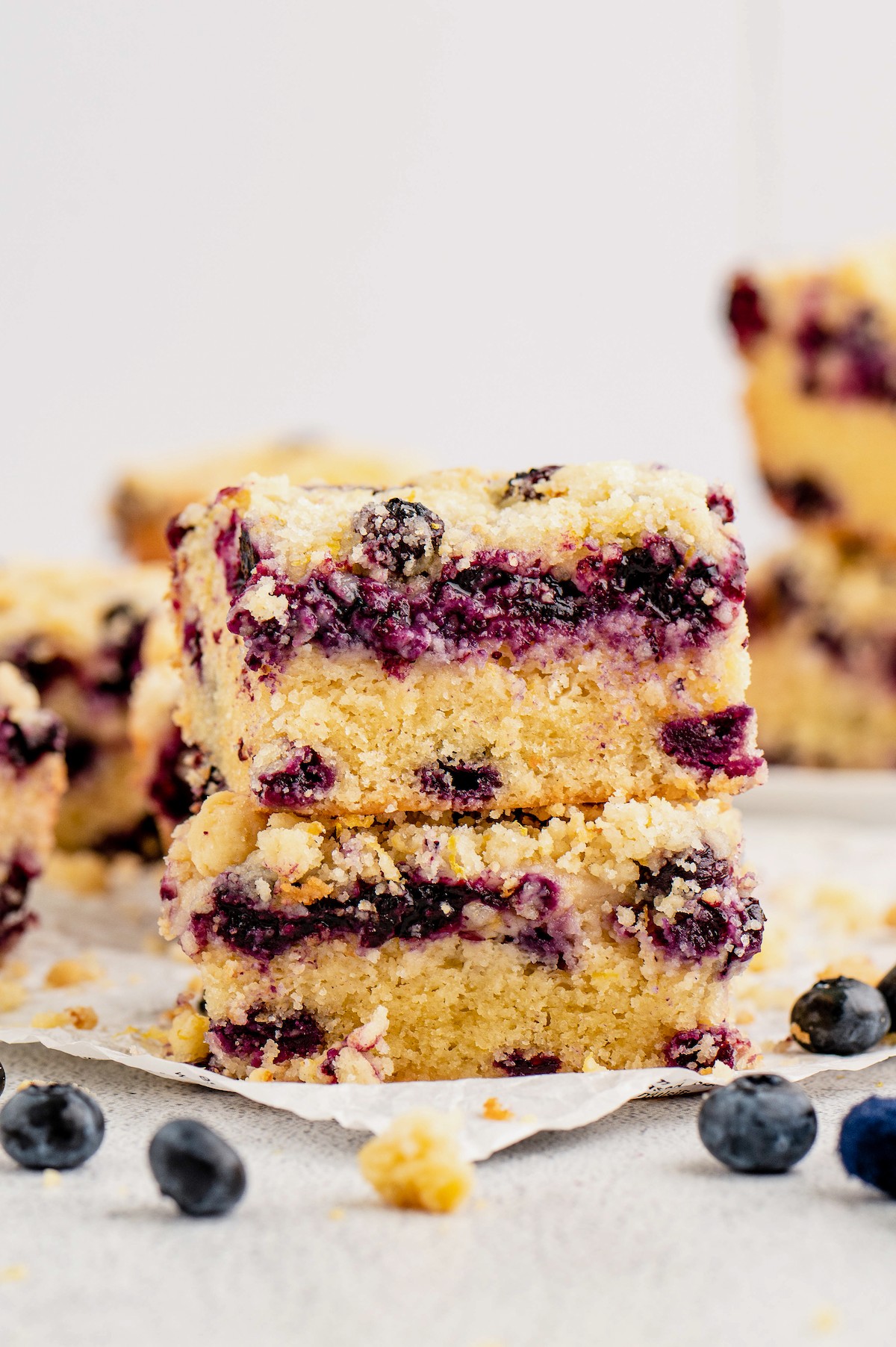 Two squares of blueberry buckle cake stacked on each other