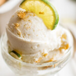 Key lime pie frozen yogurt in a dish, with garnishes.