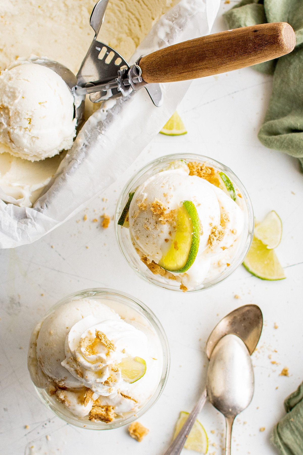 Two servings of homemade frozen yogurt garnished with citrus and graham crackers.