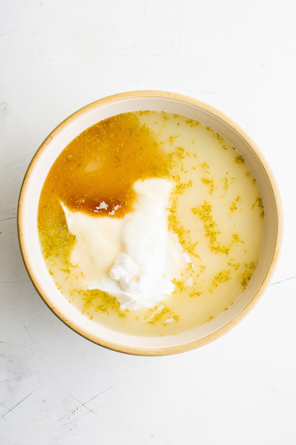 Key lime pie frozen yogurt ingredients in a mixing bowl.