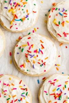 Close-up shot of frosted sugar cookies decorated with sprinkles.