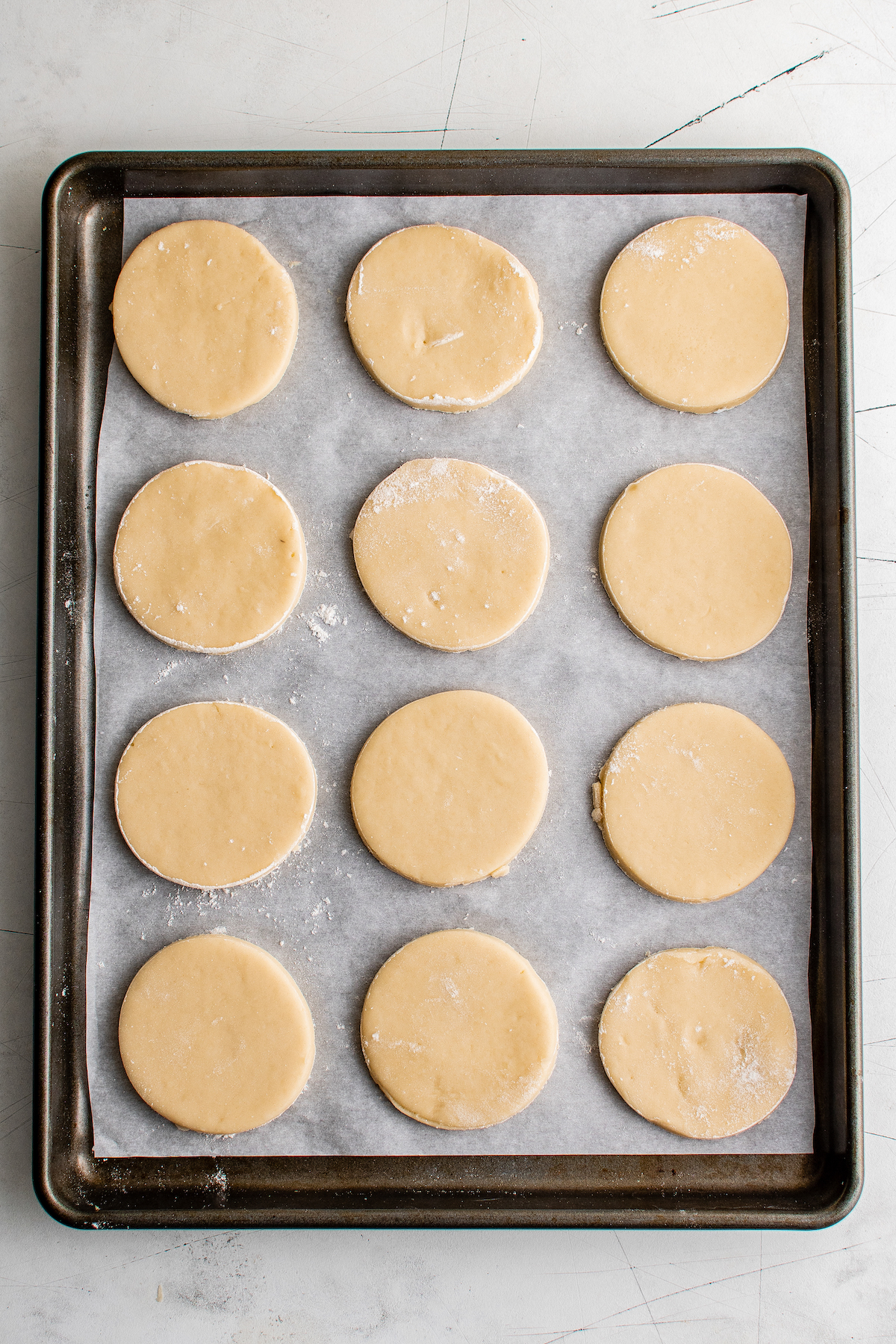 Circles of unbaked dough on a baking sheet.