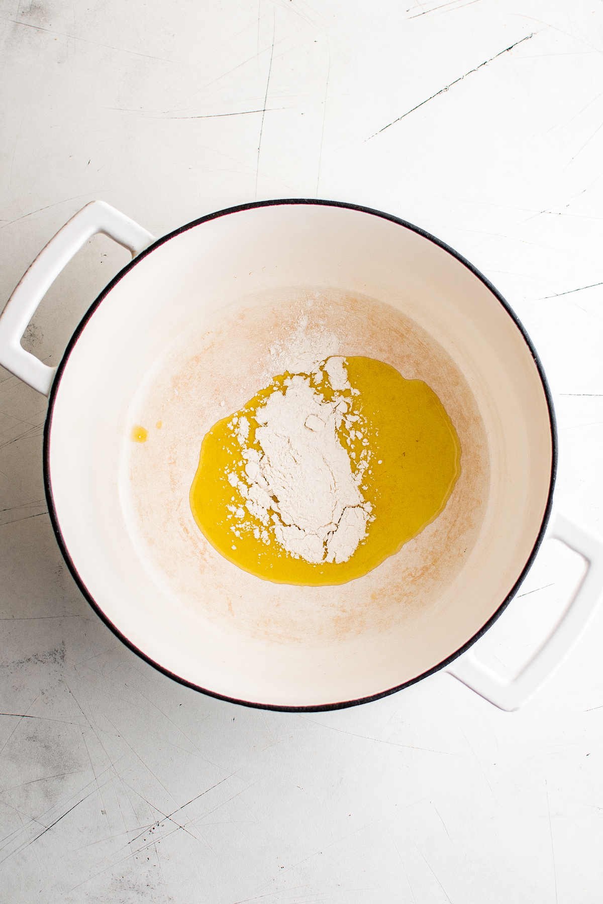 Olive oil and flour cooking in a Dutch oven.