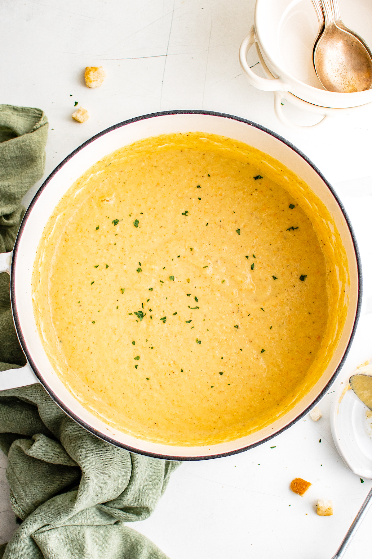 A Dutch oven filled a little more than halfway with creamy, blended cauliflower soup.