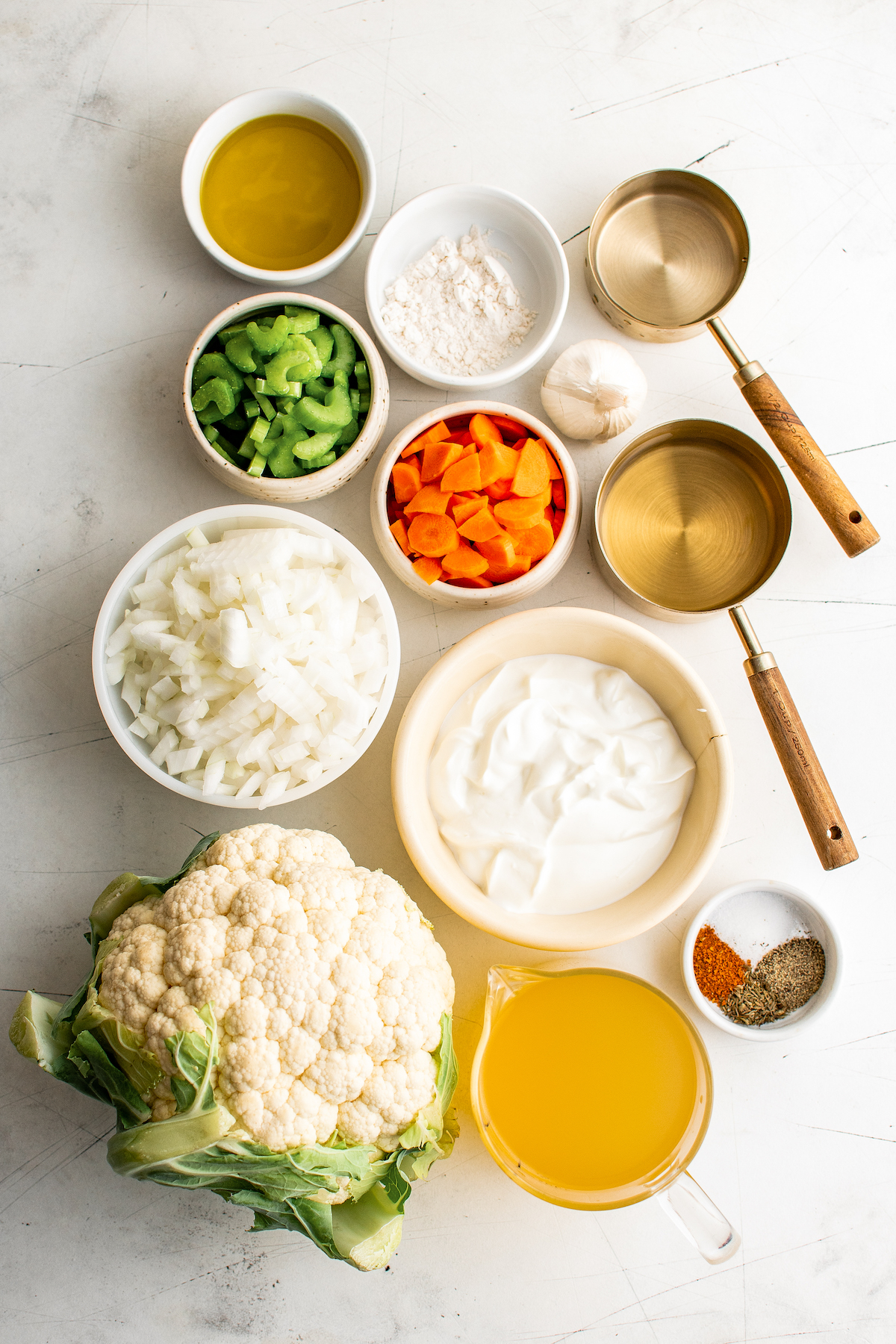 From top left: Olive oil, all purpose flour, water, celery, carrots, white wine, onion, Greek yogurt, seasonings, cauliflower, chicken broth.