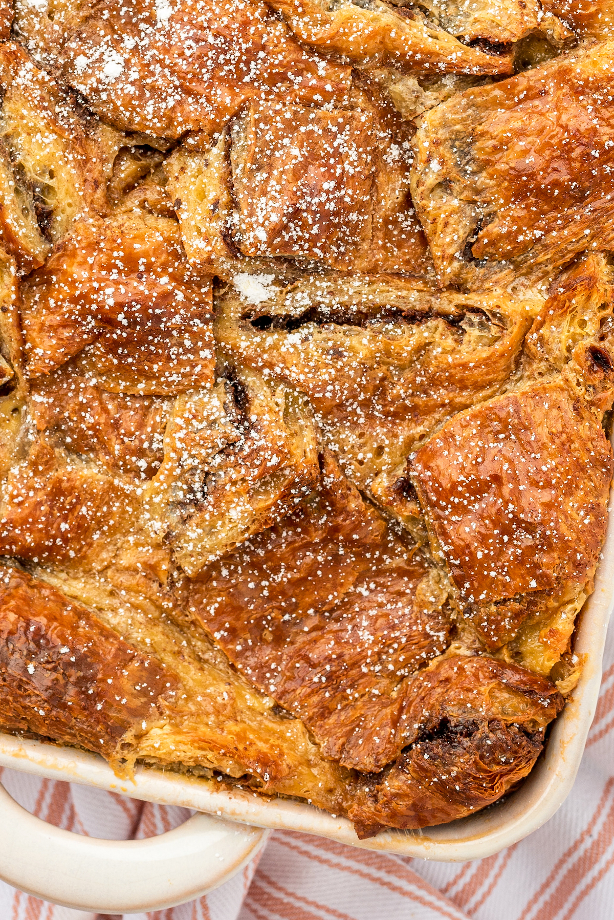 Close-up shot of bread pudding made with chocolate hazelnut spread and croissant chunks.