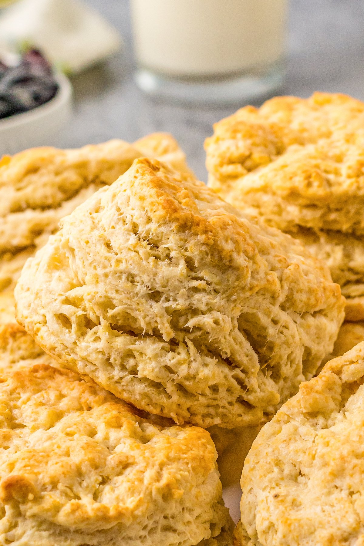 Buttermilk biscuits piled together. The layers are clearly visible from the side of the biscuits.