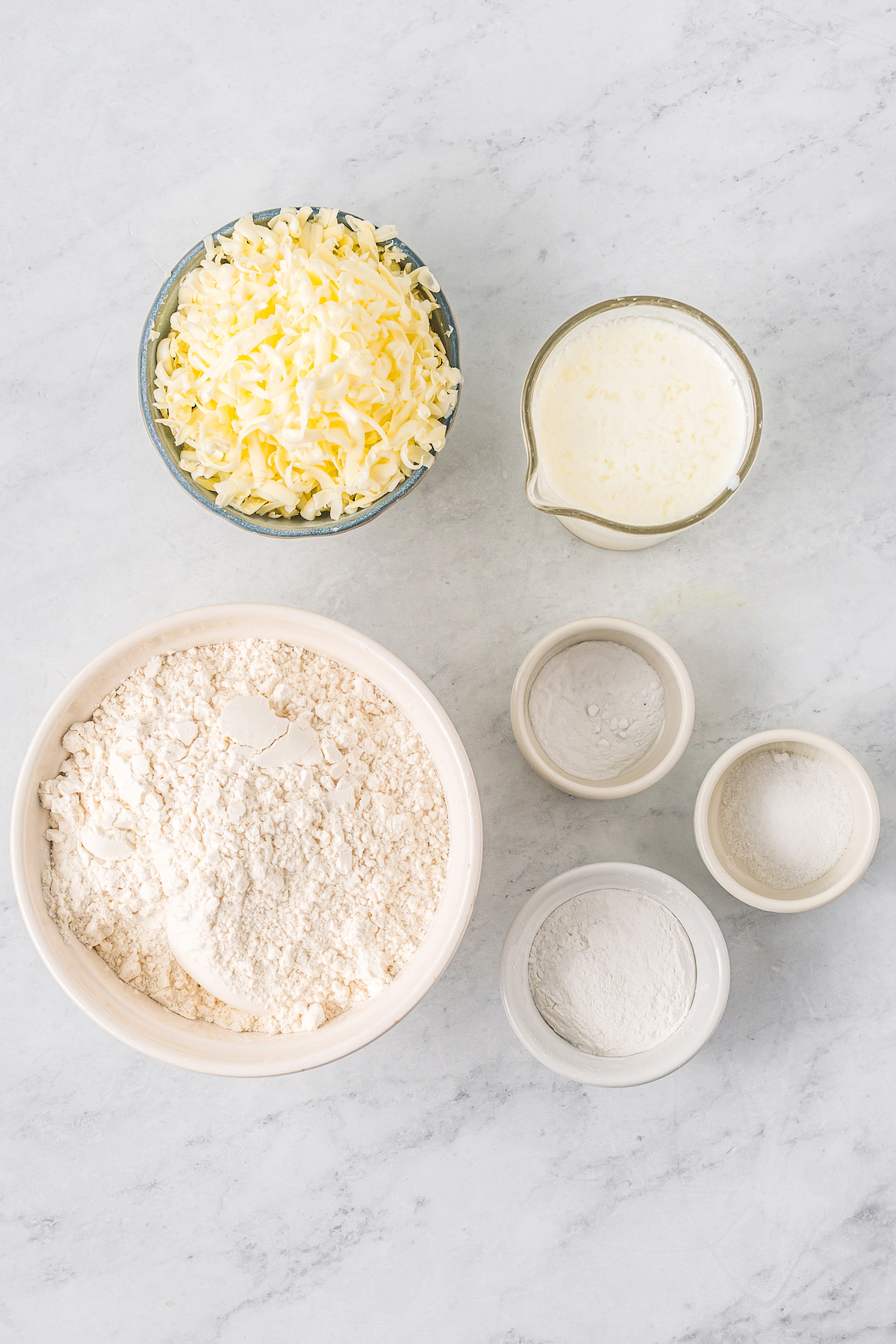 From top: Grated butter and shortening, buttermilk, flour, baking powder, baking soda, and salt.