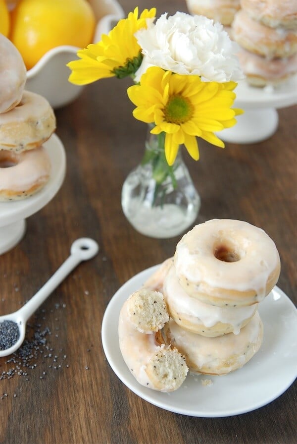 Stack of lemon poppy seed donuts on a plate.