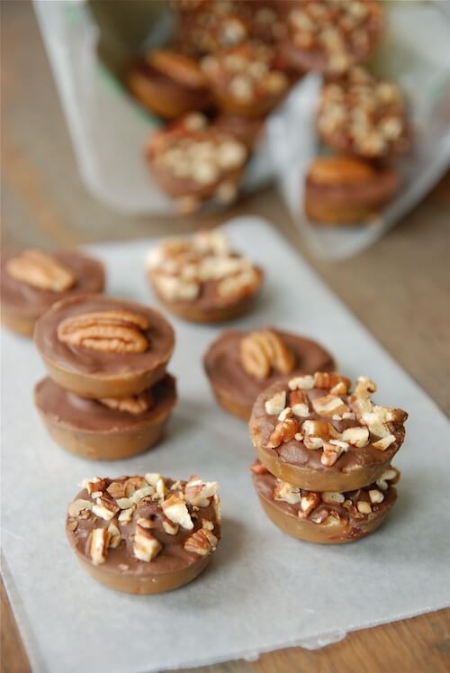 Texas pecan roca stacked on top of each other on parchment paper