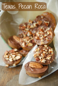 An assortment of pecan roca laid out over parchment paper.