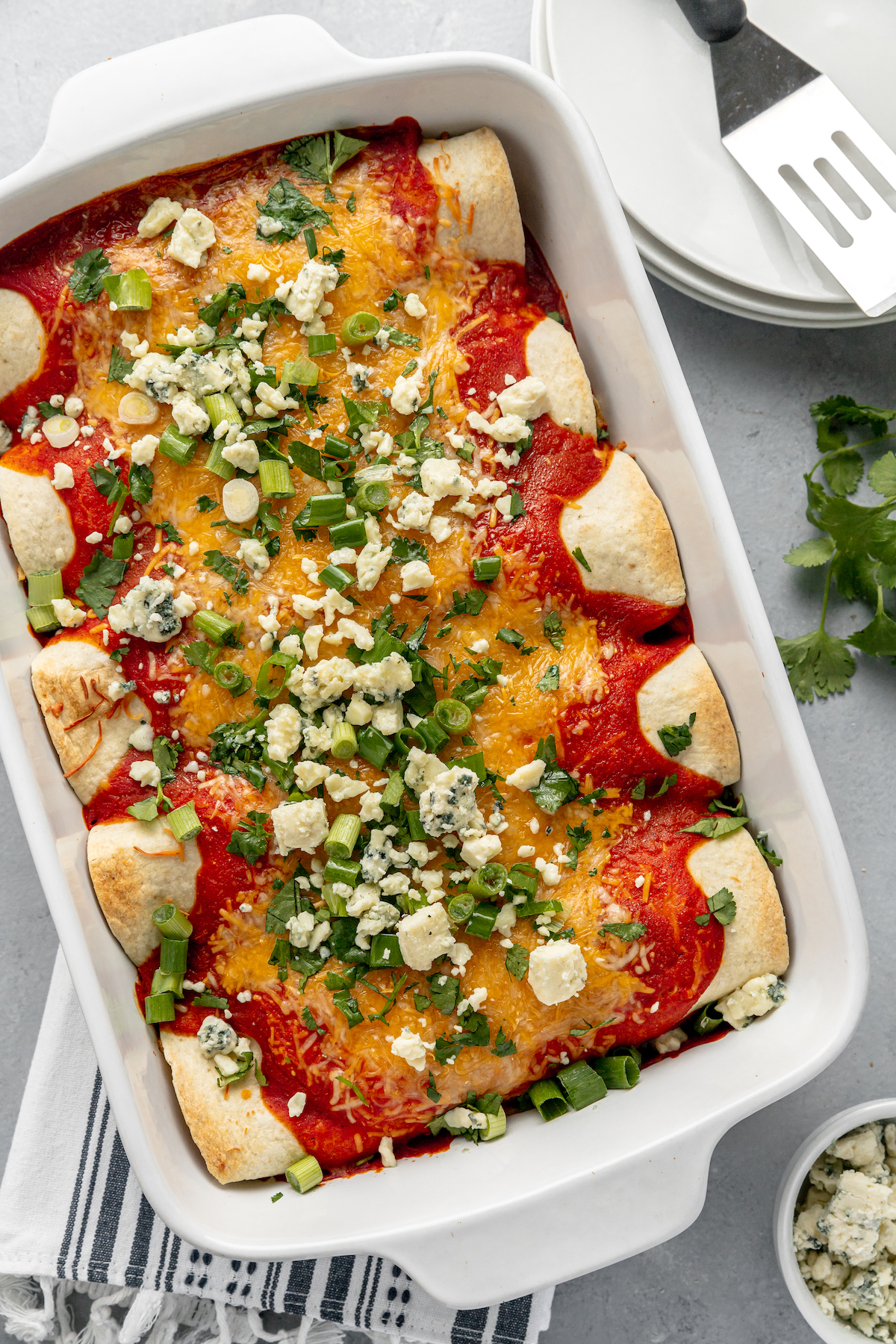 Baked enchiladas topped with bleu cheese and green onions.