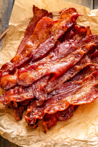 Crispy bacon strips on parchment paper.