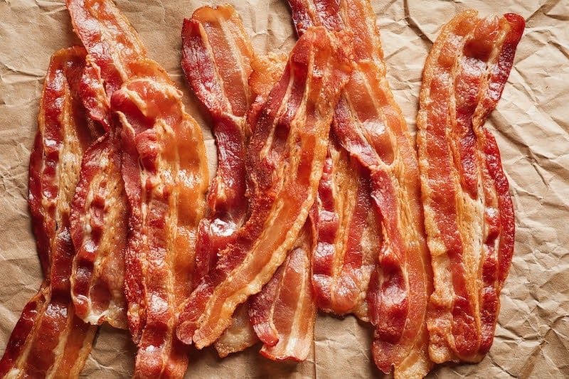 Crispy baked bacon on parchment paper