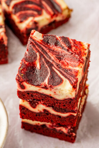 A stack of three red velvet cheesecake brownies.