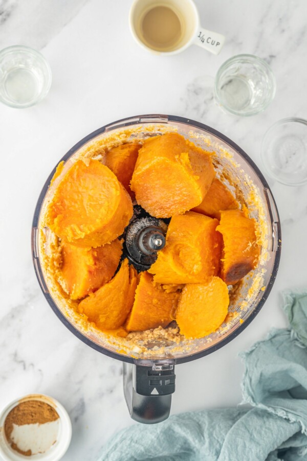 Adding the sweet potatoes to the food processor.