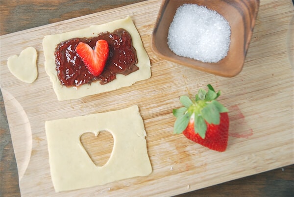 A fresh strawberry slice on jelly and pie crust.