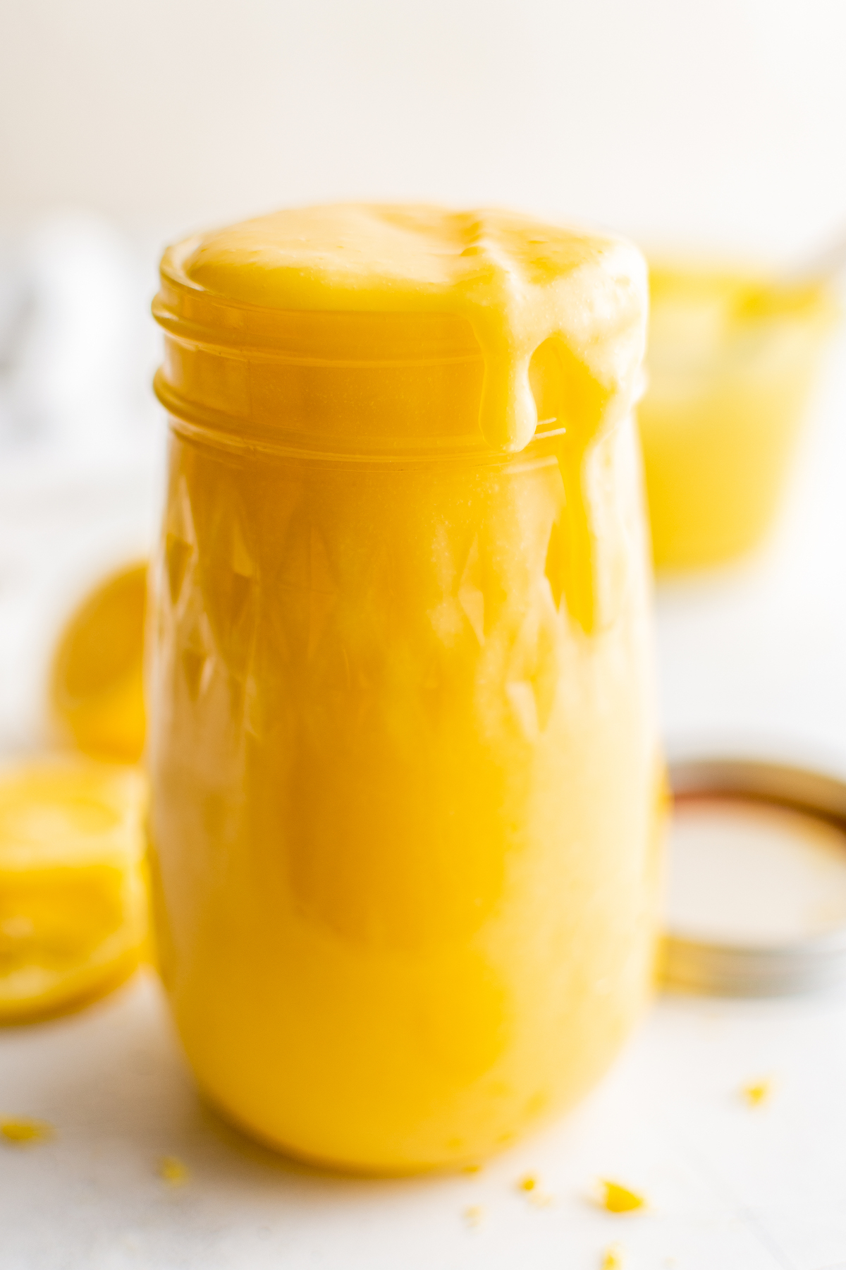 An open jar of creamy lemon dessert topping.
