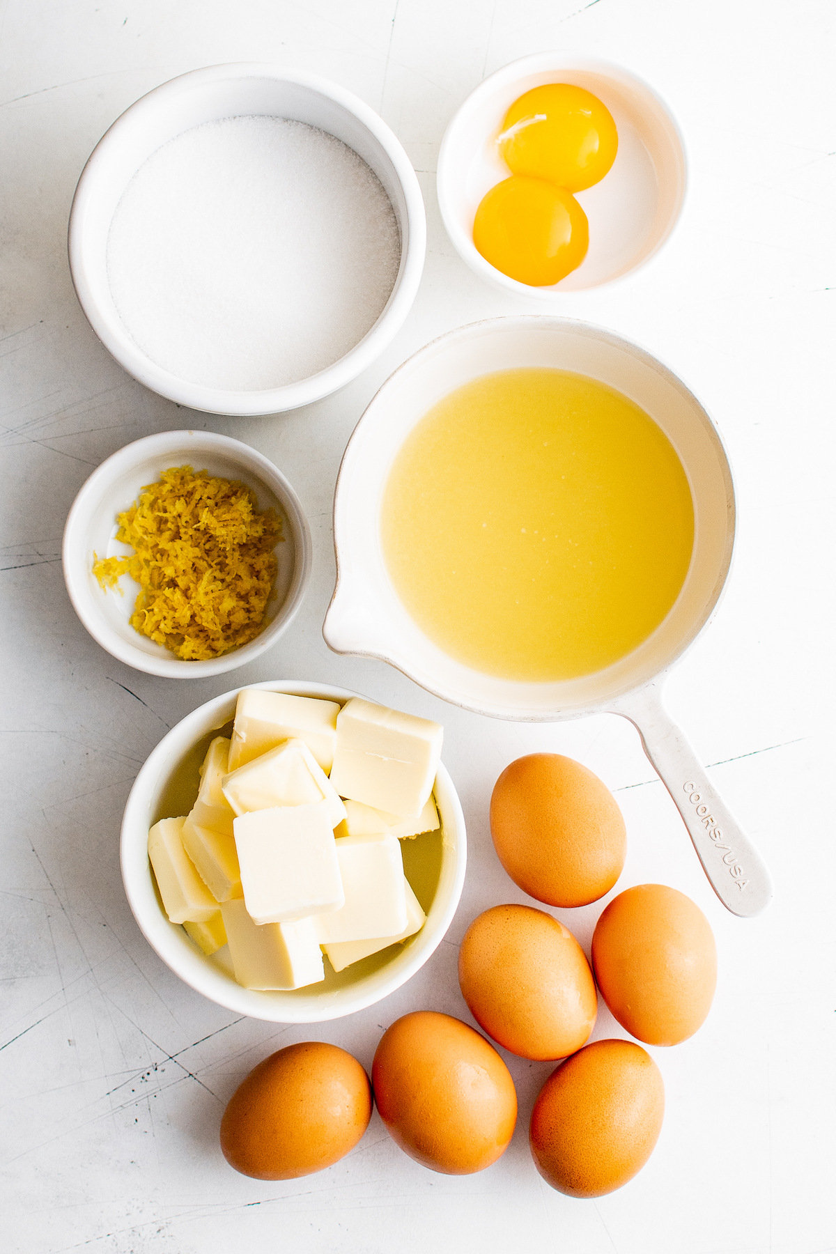 From top: Sugar, egg yolks, graham cracker crumbs, lemon juice, butter, eggs.