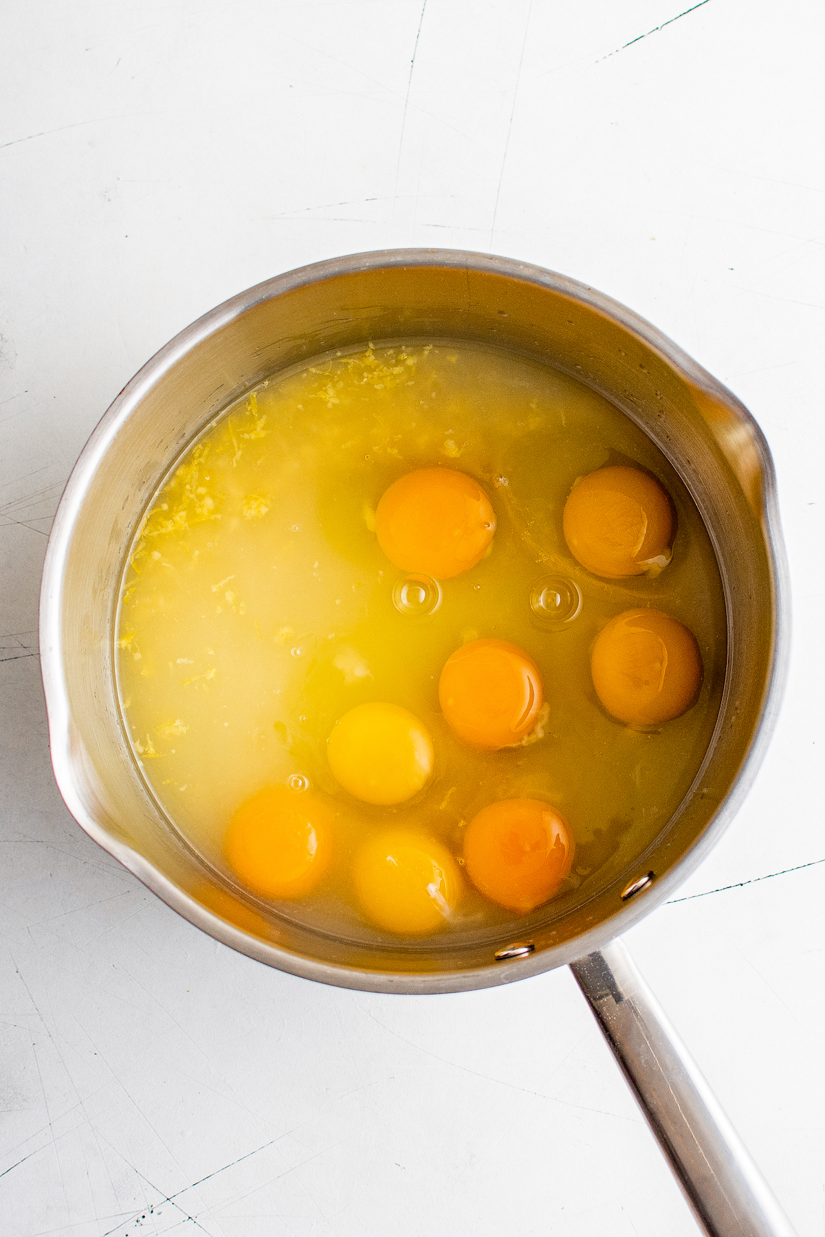 Lemon juice, zest, eggs, and sugar in a saucepan.
