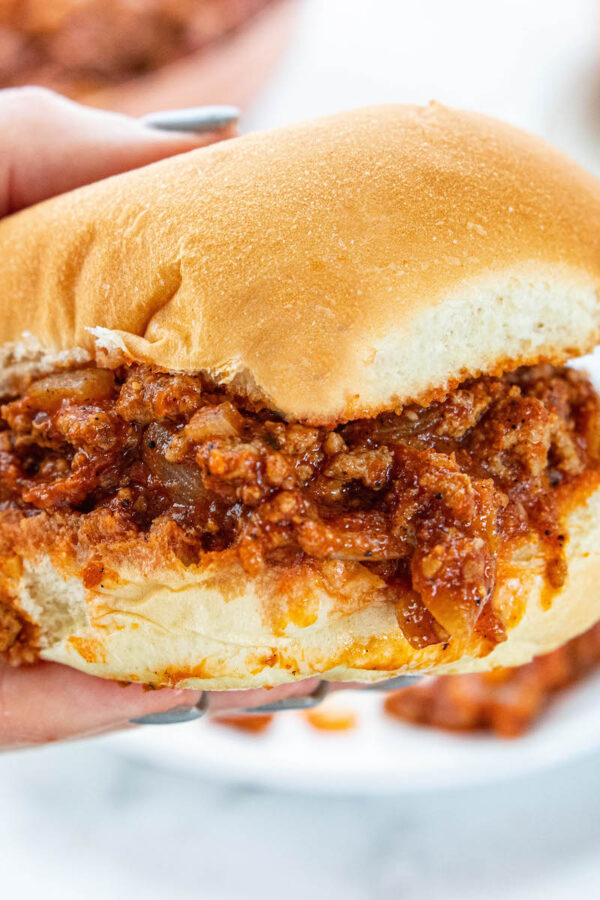 Sloppy Joes sandwich being held in hand.