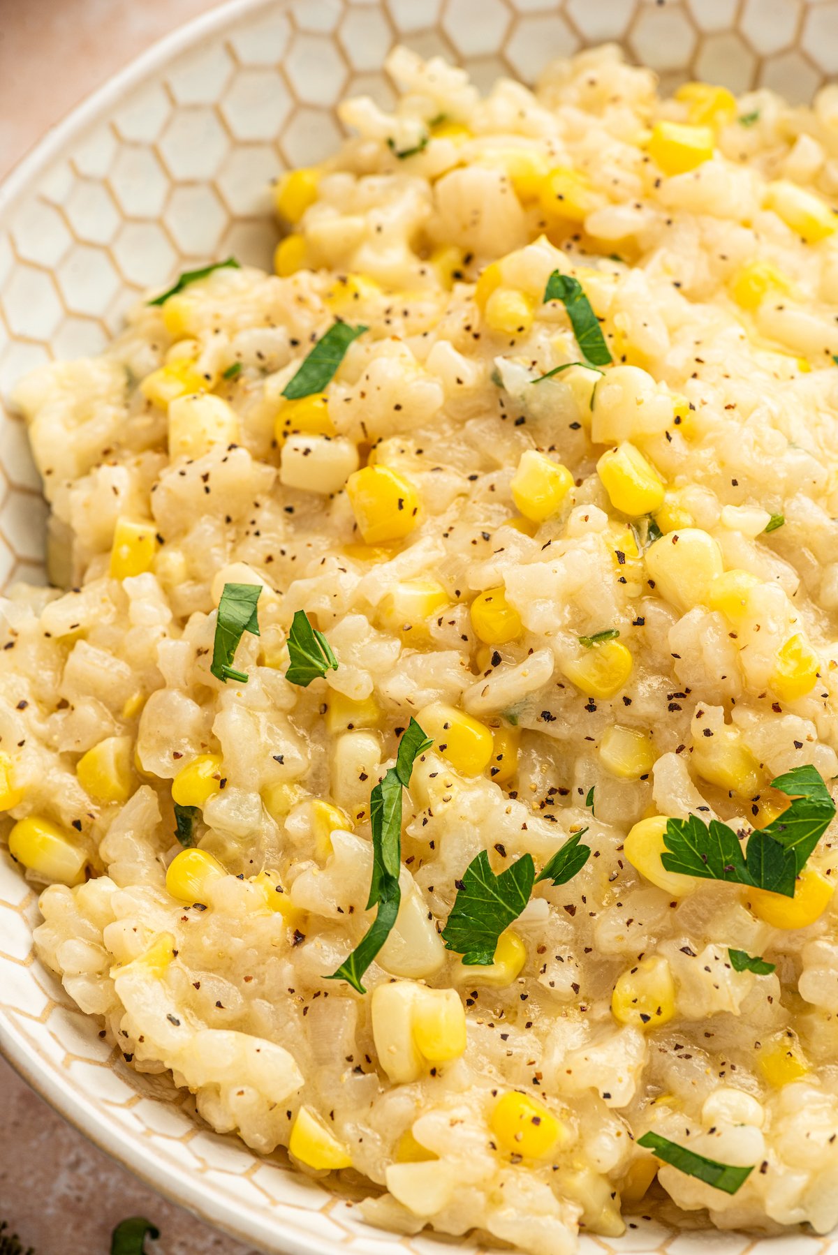 Sweet corn risotto with fresh parsley on top.