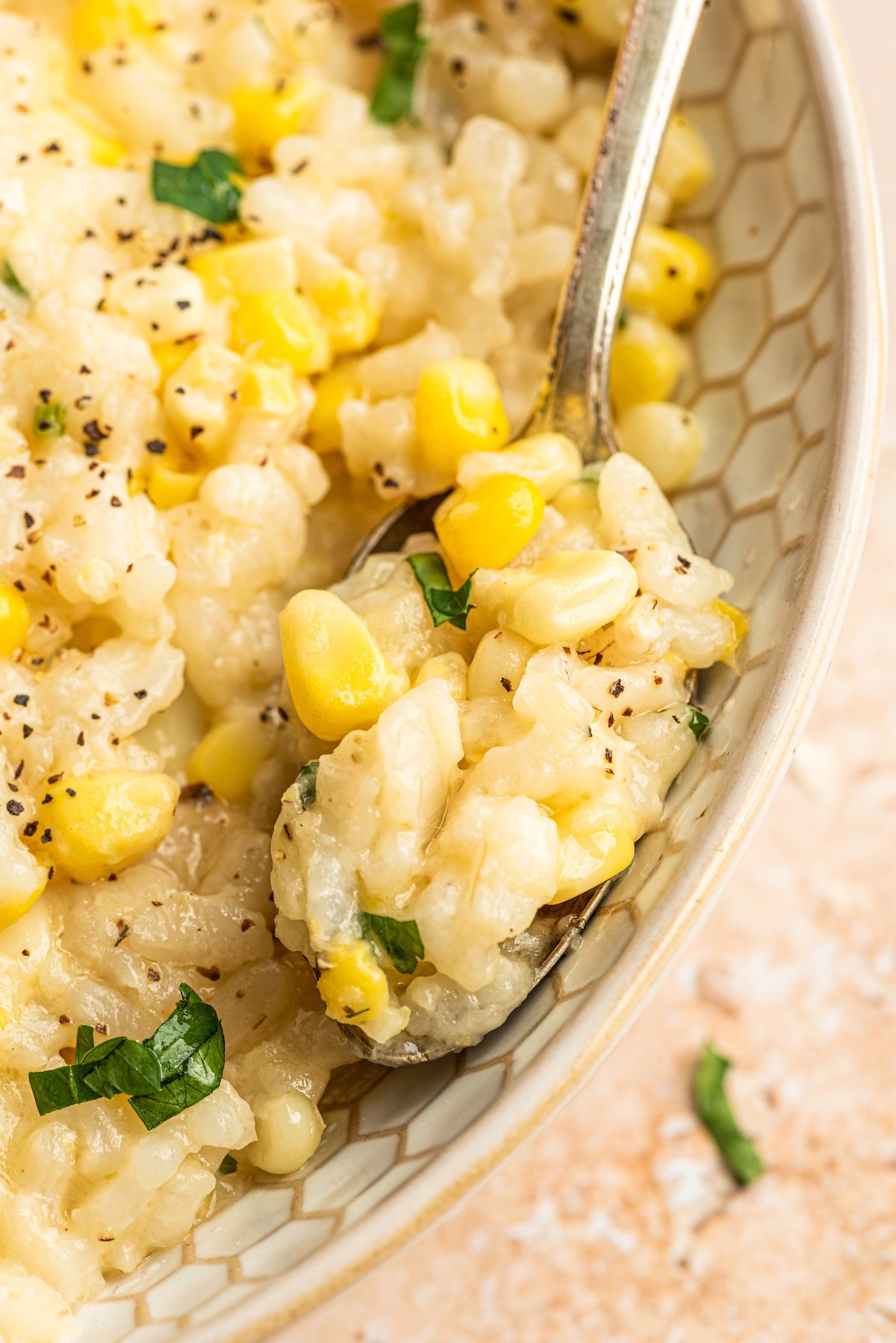 Close-up of sweet corn risotto in a spoon.