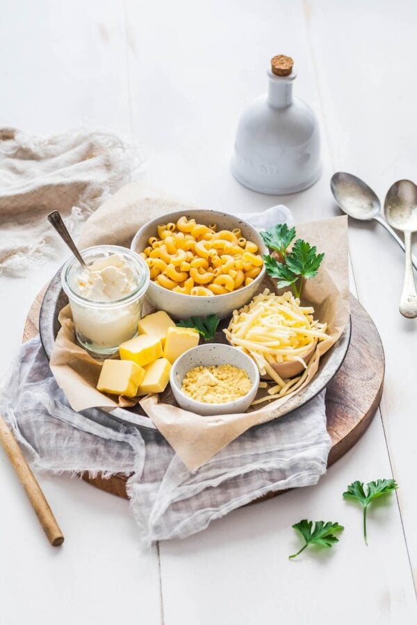 A platter with sour cream, cheese, butter, cream cheese and noodles.